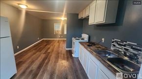 Oak Ridge apartment for rent - A kitchen with wooden floors and white appliances.