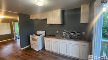 Oak Ridge apartment for rent - A kitchen with white cabinets and a wood floor.