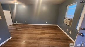 Oak Ridge apartment for rent - A room with wooden flooring and a window with blinds.