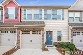 Concord house for rent - A two-story house with a red and beige exterior and a blue front door.
