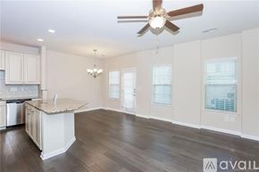 Concord house for rent - A spacious kitchen with a fan and a chandelier.