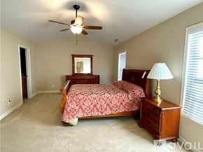 Fayetteville townhouse for rent - A bedroom with a bed, dresser, and ceiling fan.