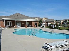 Fayetteville townhouse for rent - A swimming pool in front of a house with a fence around it.
