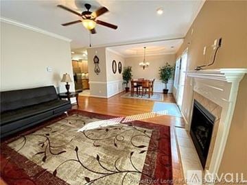Fayetteville townhouse for rent - A living room with a black couch and a rug with a design on it.