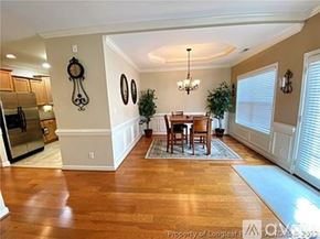 Fayetteville townhouse for rent - A dining room with a wooden table and chairs.