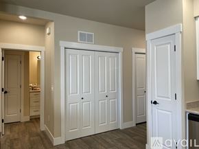 Missoula apartment for rent - A room with white doors and a tiled floor.