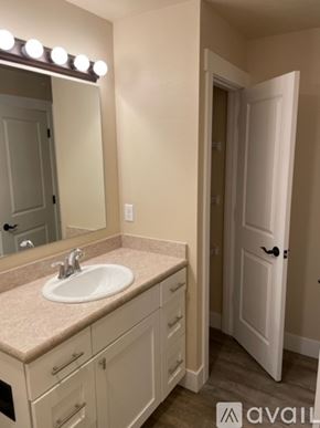 Missoula apartment for rent - A bathroom with a sink, mirror, and lighting fixture.