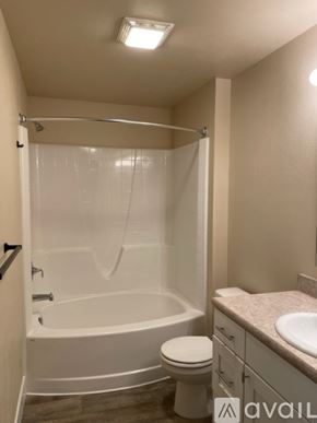 Missoula apartment for rent - A bathroom with a toilet, sink, and bathtub.