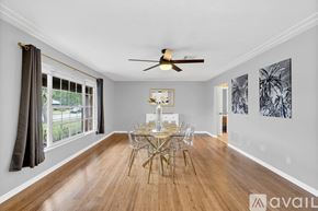 Titusville house for rent - A dining room with a wooden table and chairs.