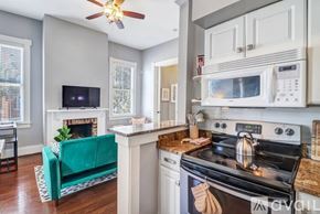 Savannah apartment for rent - A kitchen with a black stove top oven and a white microwave above it.