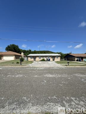 Copperas Cove house for rent - A parking lot with a building in the background and a clear blue sky.