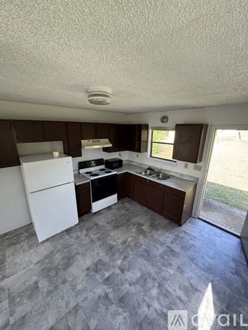 Copperas Cove house for rent - A kitchen with white appliances and a tile floor.
