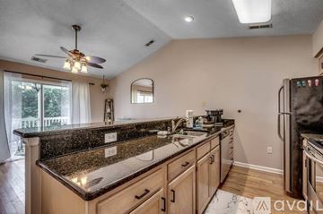 Myrtle Beach condo for rent - A kitchen with granite countertops and a ceiling fan.