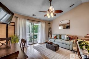 Myrtle Beach condo for rent - A living room with a couch, a coffee table, and a ceiling fan.
