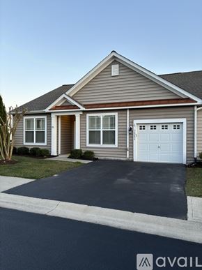 Selbyville condo for rent - A house with a brown roof and a white garage door.