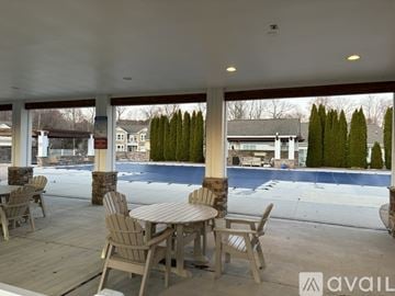 Selbyville condo for rent - A patio with a table and chairs overlooking a pool.