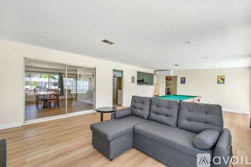 Garden Grove house for rent - A living room with a grey sofa and a billiard table.