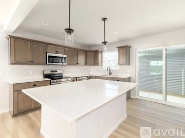 Verona house for rent - A modern kitchen with a white island and wooden cabinets.
