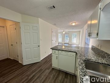 Santa Rosa Beach apartment for rent - A kitchen with white cabinets and a granite countertop.
