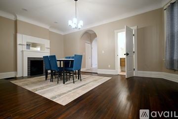 Cincinnati house for rent - A living room with a fireplace and a dining table set up.