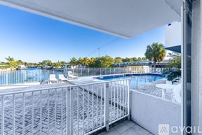 North Miami apartment for rent - A spacious room with tiled flooring and a sliding glass door leading to a balcony.