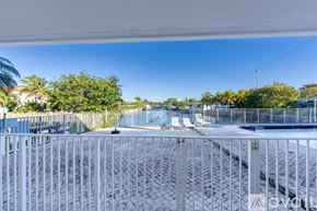 North Miami apartment for rent - A spacious room with tiled flooring and a sliding glass door.
