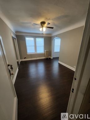 Oak Park apartment for rent - A room with wooden floors and a ceiling fan.
