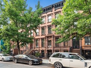 New York apartment for rent - A black car is parked on the side of a street.