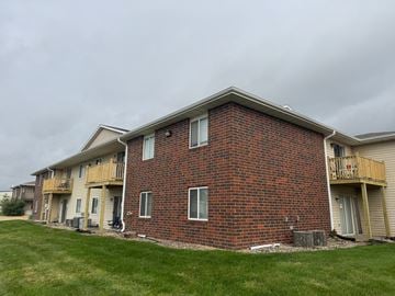 Fremont apartment for rent - A red brick building with a balcony on the second floor.