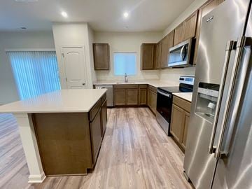 Louisville house for rent - A kitchen with a refrigerator on the right side.