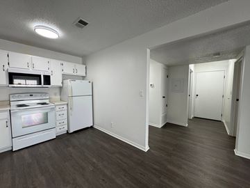 Fremont apartment for rent - A kitchen with white appliances and wood floors.
