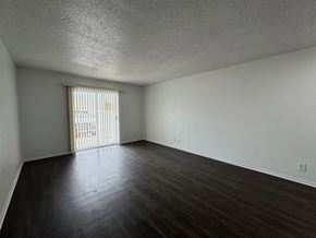Fremont apartment for rent - A room with a window and wooden floors.