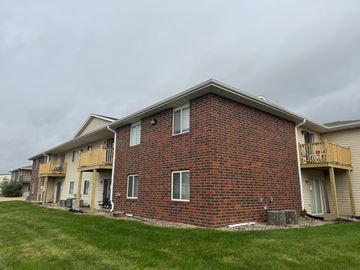 Fremont apartment for rent - A red brick building with a balcony on the second floor.