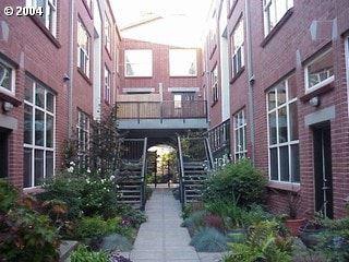Portland apartment for rent - A courtyard with a staircase surrounded by red brick buildings.