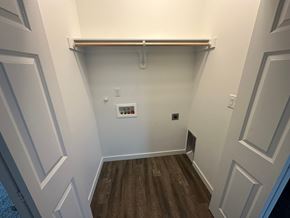 Benton City house for rent - A white hallway with wood floors and white walls.