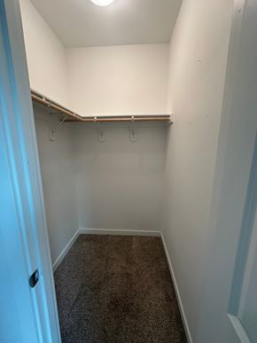 Benton City house for rent - A small, empty room with a carpeted floor and a door on the left.