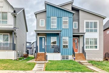 Calgary apartment for rent - A blue and grey house with a white door and windows.