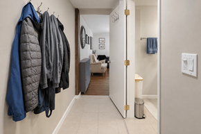 Vancouver apartment for rent - A hallway with a row of coats hanging on the wall.