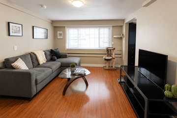 Vancouver apartment for rent - A living room with a grey couch and a coffee table.