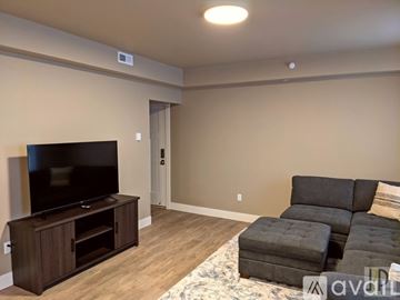 Butte apartment for rent - A living room with a grey couch and a television.