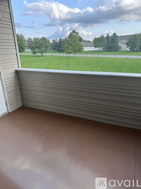 Caledonia condo for rent - A room with a view of a green lawn and trees.