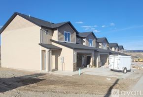 Elko apartment for rent - A row of houses with a white van parked in front of them.