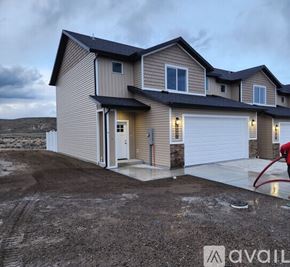 Elko apartment for rent - A house with a garage and a driveway in front of it.