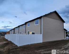 Elko apartment for rent - A row of houses with a white fence in front.