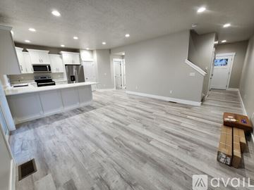 Elko apartment for rent - A spacious kitchen with white cabinets and a grey floor.