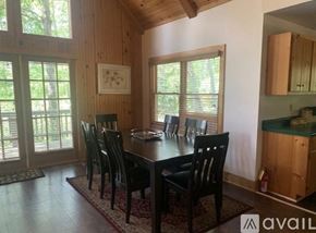 Dillard house for rent - A dining room with a table and chairs.
