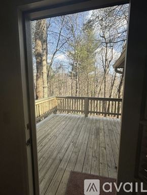 Dillard house for rent - A wooden deck with a view of trees and sky.