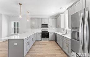 Nashville apartment for rent - A modern kitchen with stainless steel appliances and wooden floors.