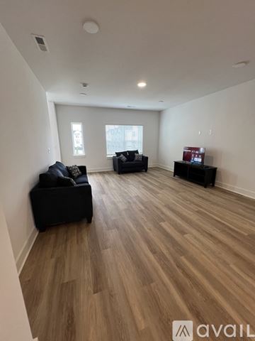 Nashville apartment for rent - A living room with black furniture and wooden flooring.