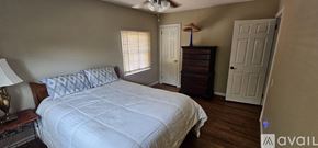 Frederick house for rent - A bedroom with a large bed and a dresser with a lamp on it.
